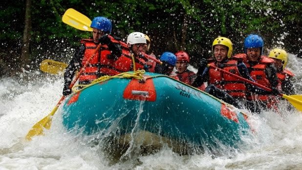 A group of people whitewater raft in the Adirondacks