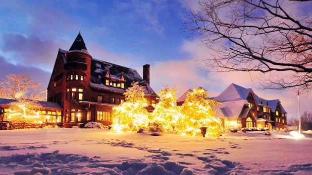 Belhurst Castle decorated with snow and bright yellow lights