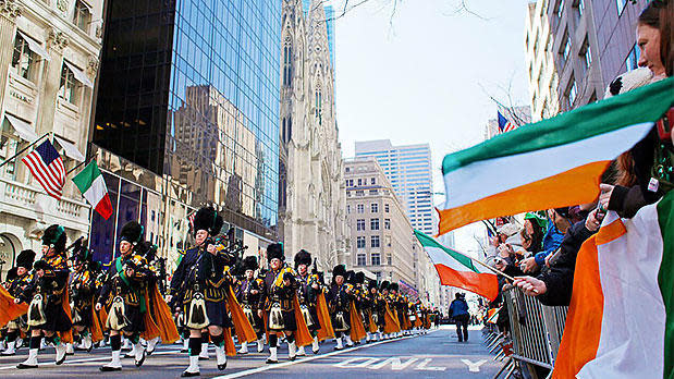 Spectators watch the St. Patrick's Day parade along Fifth Avenue in Manhattan