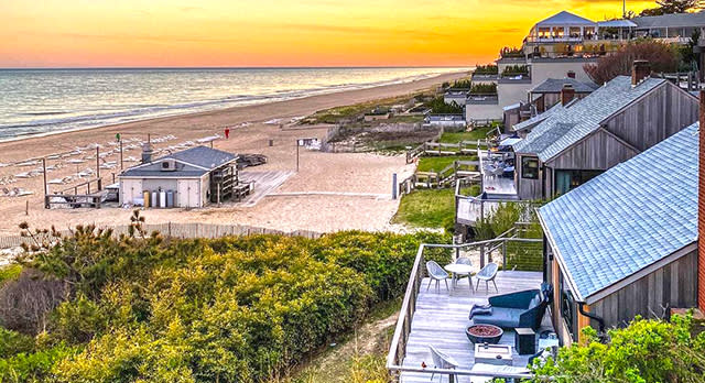 The sun setting over the beach and seaside houses in Montauk in the Hamptons
