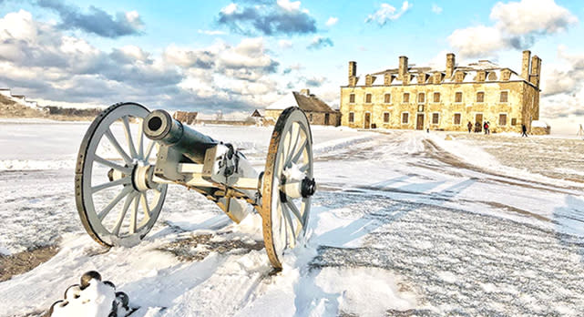An old cannon sitting in front of Old Fort Niagara in the snow