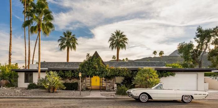 Home with car in front at Green Fairway Estates, built by Alexanders and designed by Richard Harris and Wexler.