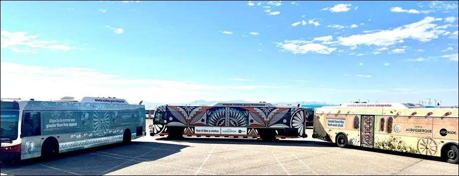 Three ABQ Ride buses wrapped in Visit Albuquerque designs