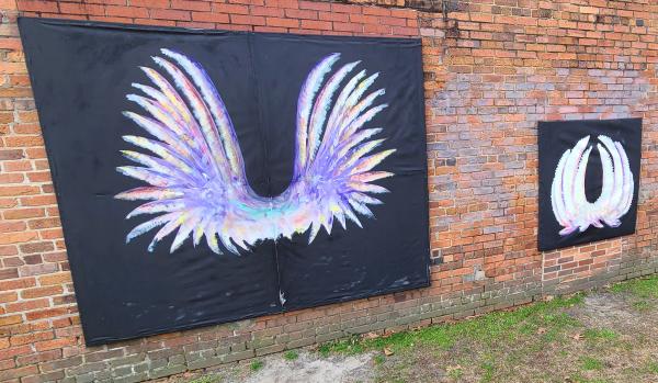 Two sets of angel wings on the outside of Greg's Pottery