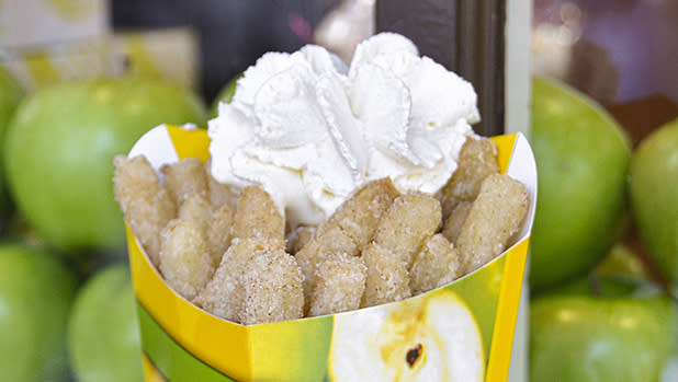 A box of apple fries topped with whipped cream in a box that reads "made fresh"