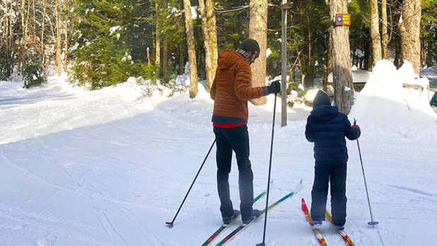 a man and a child cross-country skiing in the catskills