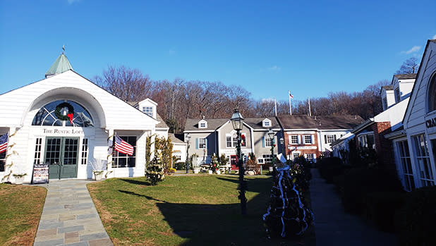 White clapboard shops decked out in wreaths at Stony Brook Village Center