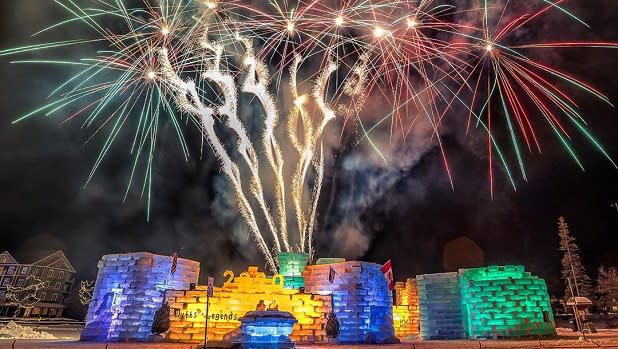 Fireworks burst above the enchanting ice castle at the Saranac Lake Winter Carnival
