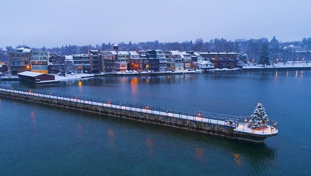 A lone Christmas tree stands perched at the end of a pier in Skaneateles during the holiday season