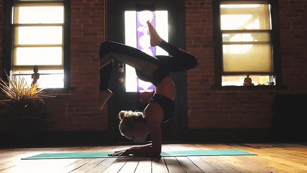 Woman standing on her elbows in a yoga pose.