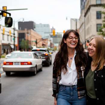 Two women walking in the Short North with arms around each other