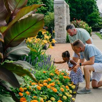 Fathers and daughter looking at flowers at Schiller Park