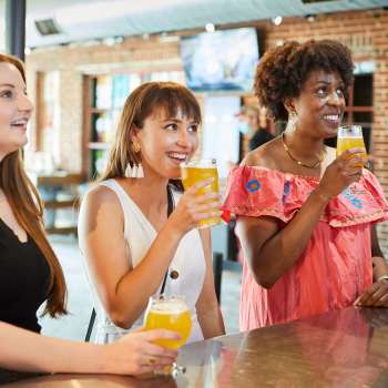 Group of girls enjoying beer at Land-Grant Brewing Company