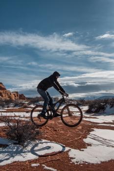 mountain biker on red dirt and snow