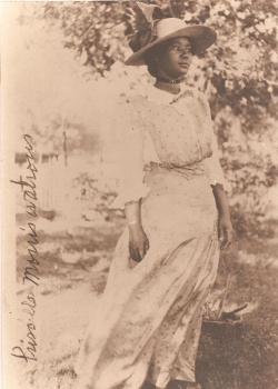 Historic photograph of young woman in turn of the century dress and hat