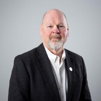 headshot of man in a suit