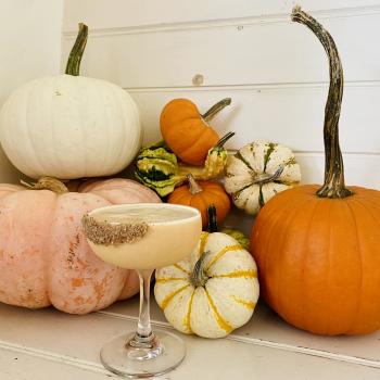 A photo of one of Egg's special fall cocktails in front of a group of pumpkins.