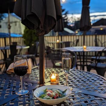 Elizabeth's American Bistro Patio with food and wine on a table