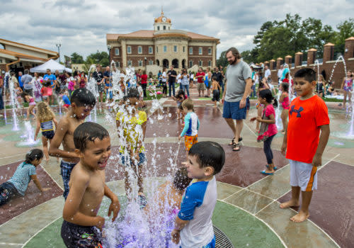 kids playing in fountain