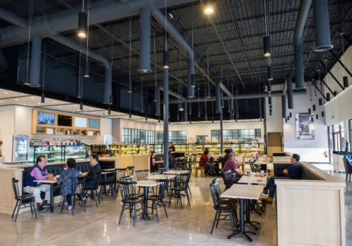 people at tables in a bakery