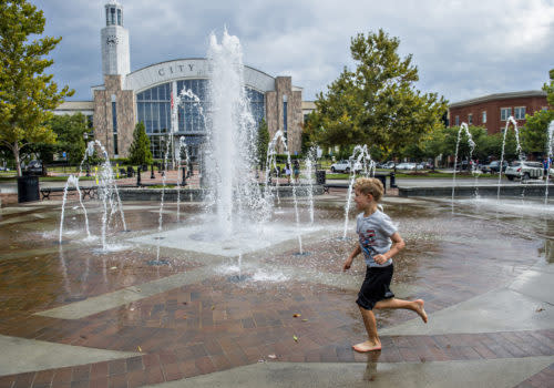 child running around fountain