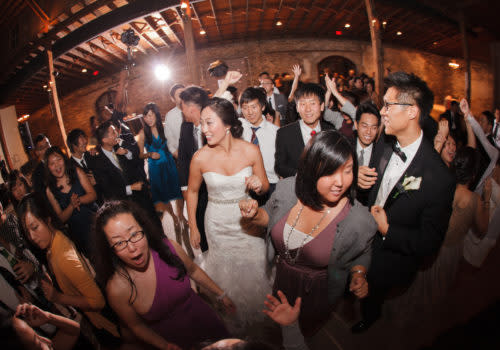 Fish-eye lens picture of people dancing at wedding