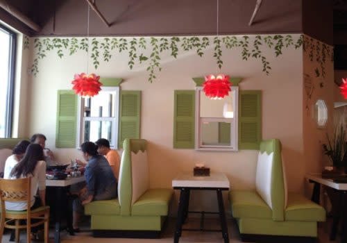 people eating at restaurant booths