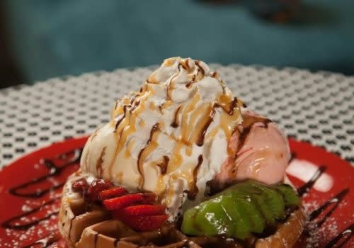 waffle topped with fruit and whipped cream