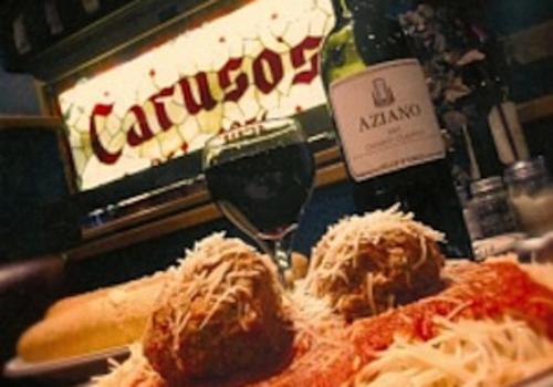Caruso's Italian restaurant's spaghetti meal with wine and bread.