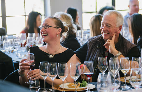 Woman and man smiling at San Francisco Wine School event