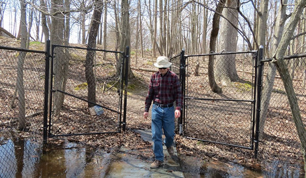 Guy Walking Out of Michael Nichols Pinhook Bog gate