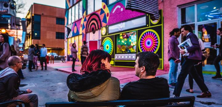 A couple sitting outside at Factory Obscura's Mix-Tape