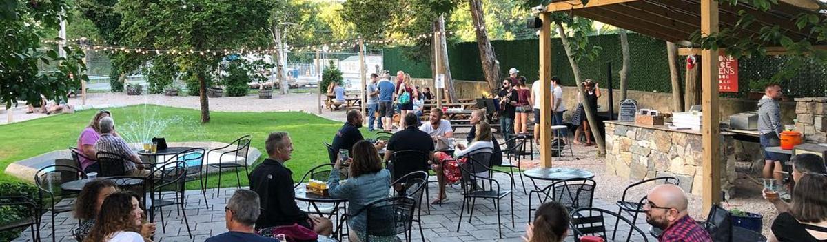 People Drinking Beer and Watching Live Music at Grey Sail Brewery Courtyard in Providence RI