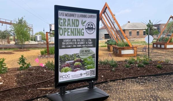 Sign and planted areas at East McKinney Learning Garden at TUPPS Brewery