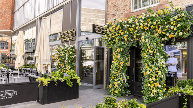 Outside of Bread Street kitchen with flowers over the door.