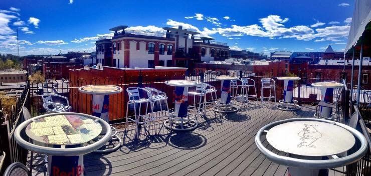 Rooftop patio with Red Bull tables at Saratoga City Tavern