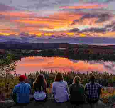 Group on top of White Sky Rock overlooking fall colors