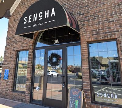 Exterior of Sencha Tea Bar with natural light reflecting on the windows.