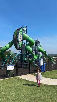 an inviting image of a playground with various play structures, including swings, slides, climbing frames, and interactive equipment.