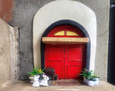 Visit McKinney tiny red door with spring plants and white bunnies