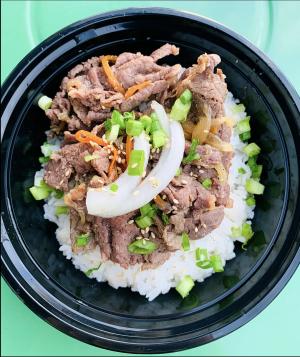 Bowl of white rice, meat and garnishes offered at ArkanSeoul