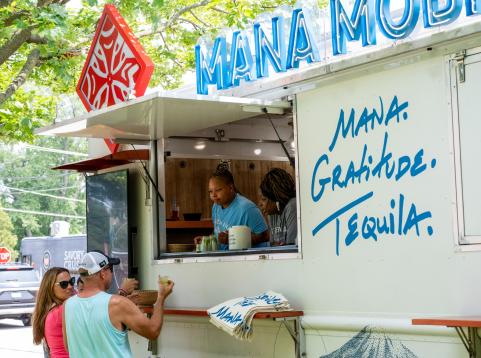 Two guests at window of food truck