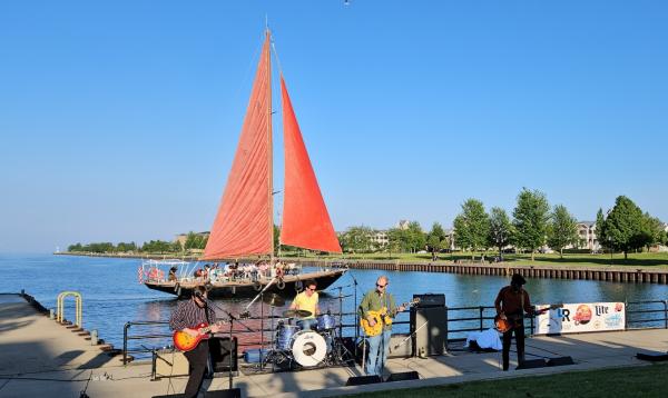 Red Witch II sailing behind Live from the Little Pier concert series