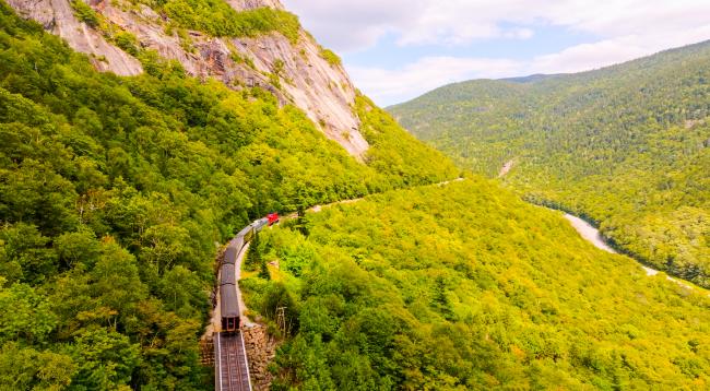 Conway Scenic Railroad - Aerial View of Mountaineer Train on Tracks with Mountain in Background)