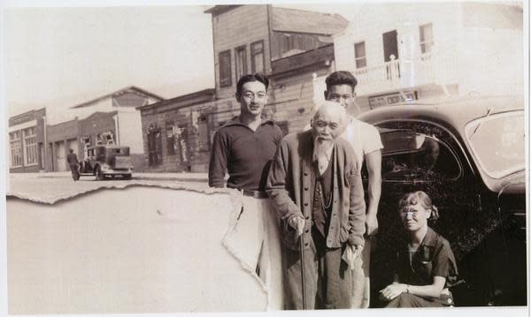 Ah Louis with beard with son Howard Louis and two unidentified people, standing in front of the Ah Louis Store in Chinatown, Palm Street. Mee Heng Low can be seen across the street.