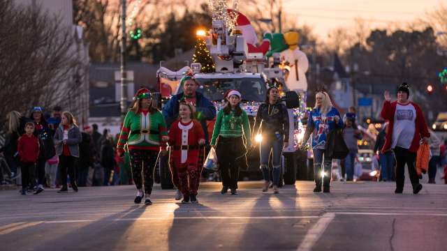 people walking in the christmas parade for lighting up downtown