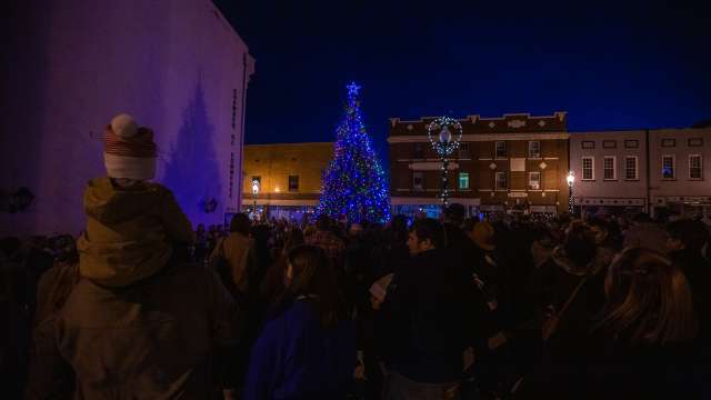 people gathered on the street in front of the christmas tree on walker square for light up downtown