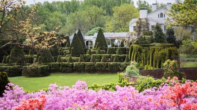 The Main House at Ladew Topiary Gardens with beautiful flowers and topiaries in front of the house