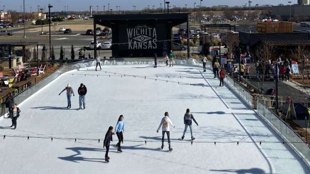 People skate on the ice rink setup at Chicken N Pickle