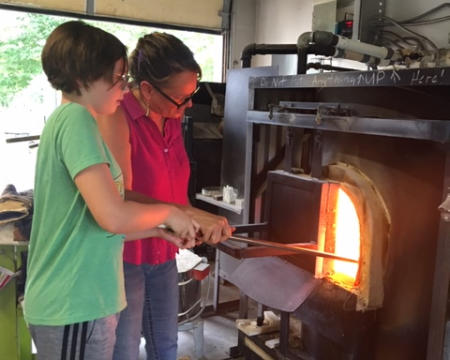 My granddaughter Callie working with Lisa before COVID. Hot Blown Glass